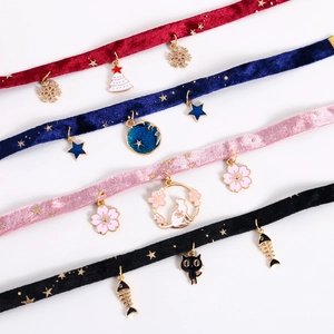 Macro shot of colorful velvet pet collars with alloy Christmas and floral pendants