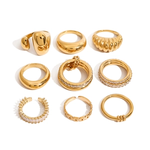 9-piece gold titanium steel ring set with zircon stones and polished textures on white base