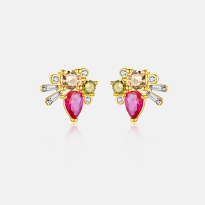 Macro detail of teardrop pink stone earring with colorful zircon accents and gold plating