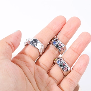 Irregular lava texture silver rings set with colorful zircons on model's hand