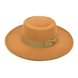 Detail of camel wool felt hat showing flat top and elegant grosgrain ribbon with bow