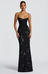 Detail of 3D floral embroidery on a black bodycon mermaid maxi dress with thin straps