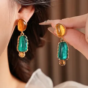 Vintage irregular resin earrings with amber stud and green textured drop in gold trim