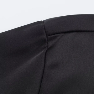 Detailed view of black satin fabric showing precise stitching and smooth silk texture