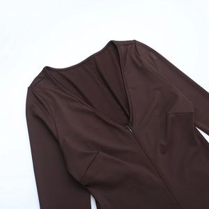 Macro detail of deep V-neckline with matching invisible zipper on dark brown bodysuit
