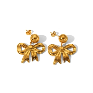 Macro detail of polished gold bow-shaped drop earrings with a smooth metallic finish