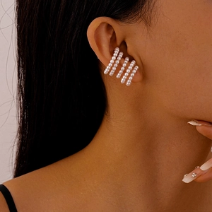 Detail of multi-layer faux pearl ear cuff showing parallel rows and non-pierced C-shape design