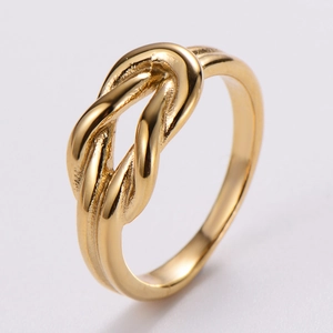 Detailed close-up of golden knot ring with smooth polished finish and spiral twist texture