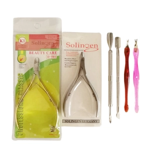 Detailed set of professional golden and silver cuticle nippers with manicure steel pushers