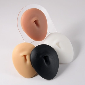 Realistic silicone ear models in four skin tones with acrylic display stand for piercing