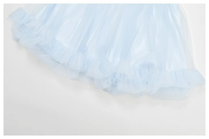 Detail of light blue layered mesh yoga skirt hem with soft ruffles and airy texture