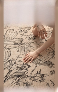 Close-up of soft beige plush rug with vintage floral patterns and thick fiber texture