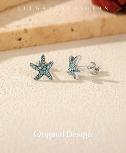 Macro shot of S925 sterling silver starfish stud earrings with turquoise stones