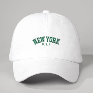 Front view of white cotton baseball cap with green NEW YORK U.S.A collegiate lettering