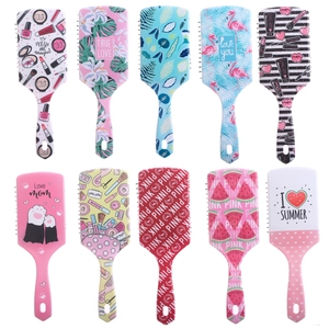 Flat lay of colorful cartoon air cushion hairbrushes with various vibrant patterns