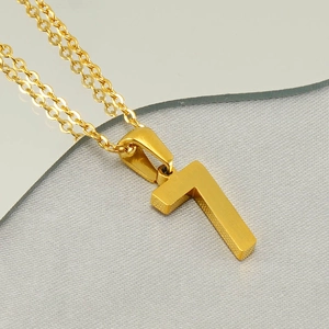 Detailed close-up of a gold-plated number 7 pendant on a classic stainless steel chain