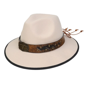 Detail of beige felt cowboy hat featuring brown leather band and bull head metal buckle