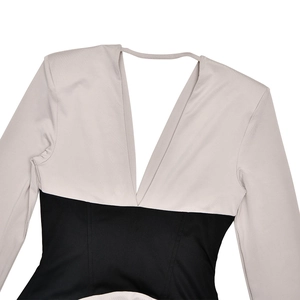 Detailed close-up of V-neckline and contrast color stitching on the slim-fit dress