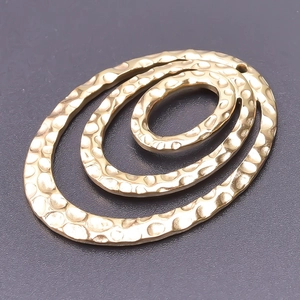 Close-up of golden hammered oval pendants for DIY 18k plated necklace jewelry