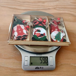 Christmas wooden gnomes ornaments set on a digital scale showing a weight of 59.8 grams