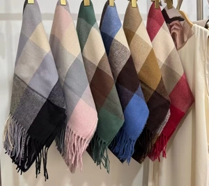 Detailed view showing various color options for the plaid cashmere scarf with long tassels