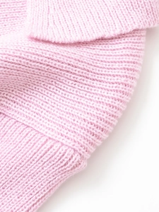 Close-up of pink knitted short sleeve fabric showing soft texture and ribbed cuffs