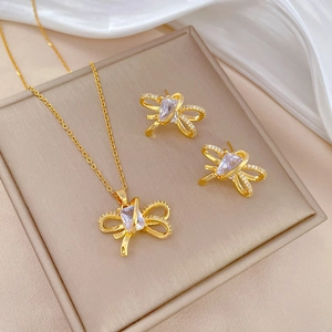 Titanium steel bow jewelry set with zircon necklace and earrings on a gift box