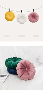 Close-up of creative pumpkin-shaped cushions in vibrant colors and plush velvet texture