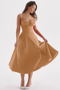 Detail view of the elegant apricot corset midi dress with sleek spaghetti straps design