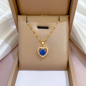 Luxurious gold heart necklace with a sparkling blue gemstone and micro-pave white zircons