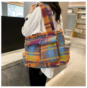 Close-up of fluffy plaid tote bag featuring vibrant orange and blue checkered patterns
