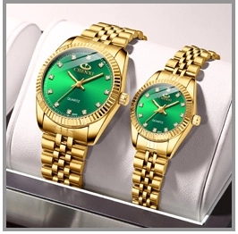 Detailed close-up of gold quartz watches with green dials on white display pillows