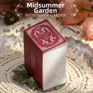 Close-up of vintage Midsummer Garden scrapbooking paper book with gold ornate patterns