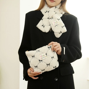 White faux shearling scarf and large cosmetic bag set with black bow patterns