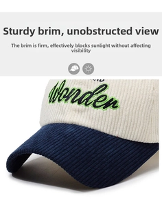 Close-up of corduroy texture and Wonder letter embroidery on the two-tone baseball cap