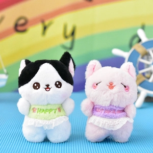 Close-up of two cute plush cat keychain dolls with lace outfits and embroidery.