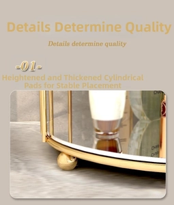 Detail of the thickened gold metal frame and mirrored base with stable spherical feet