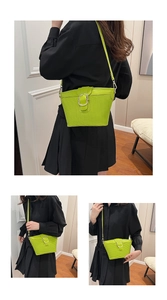 Close-up of bright green crossbody bag with woven texture and silver hardware details