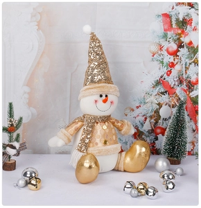Detail of sitting Christmas snowman plush with silver sequins and gold hat in festive room