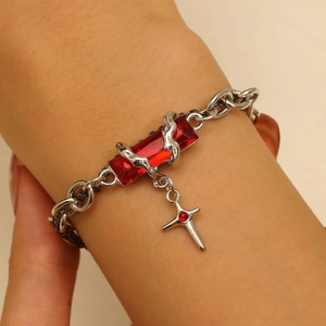 Gothic silver bracelet featuring a red gemstone with a vine-wrapped cross pendant