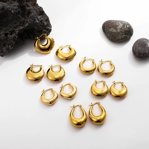 Collection of hollow 18K gold chunky hoop earrings on white background with stones