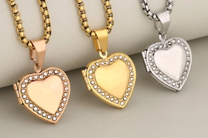 Three heart-shaped locket pendants with rhinestones in rose gold, gold, and silver