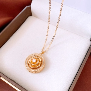 Detailed view of vintage gold rose pendant with zircon stones in a premium jewelry box