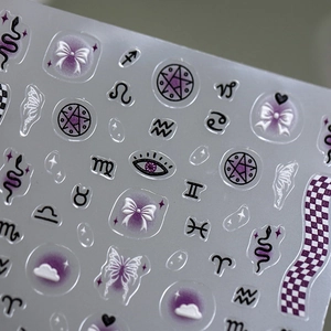 Starry galaxy nail art stickers with purple bows, butterflies, and zodiac symbols