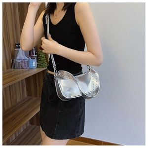 Silver metallic PU shoulder bag with rivet strap detail shown on a female model