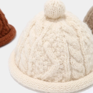 Chic cable knit beanie with top bobble and rolled edge in cream white for winter warmth