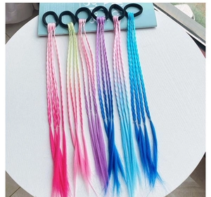 Detail of colorful braided hair extensions with black elastic bands for girls' styling