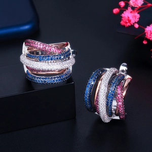 Detail of interlocking multi-layer earrings with pink, blue, and white zircon stones
