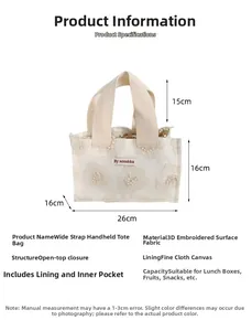 Detail view of cream canvas tote bag showing 26x16cm dimensions and floral embroidery