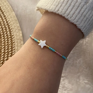 Handmade beaded bracelet with pastel seed beads and a white shell star charm for women